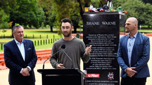 Remembering a legend: Australian cricketer Glenn Maxwell (centre) speaks as former Australian Rules footballer Aaron Hamill (right) and media perso<em></em>nality Eddie McGuire look on during a press co<em></em>nference in front of a statue of Shane Warne in Melbourne on Tuesday. — AFP