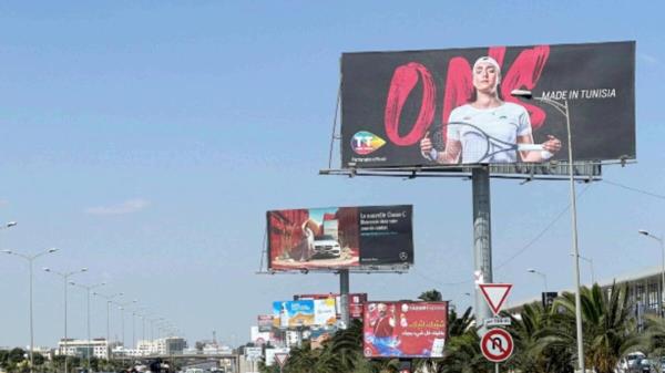 Vehicles drive past a billboard depicting Tunisian tennis player Ons Jabeur in Tunis. — Reuters